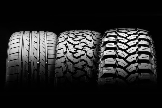 Mud allseason all terrain tires and road wheel on a black background