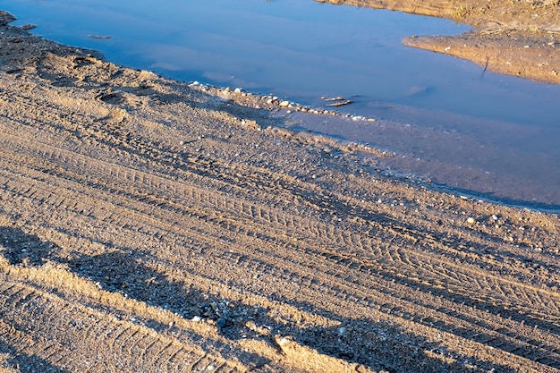 Muddy road on a dirt road outside the city