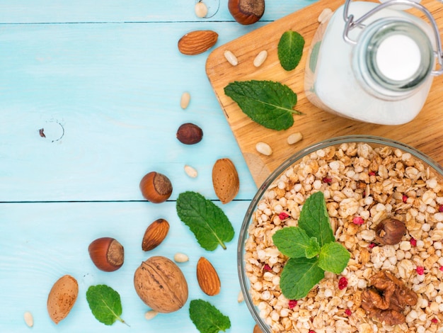 Muesli milk and nuts on blue background