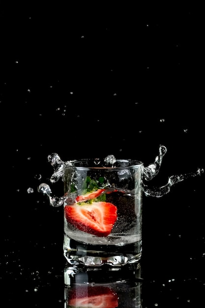 Muesli with yogurt and berries in a glass on a white background