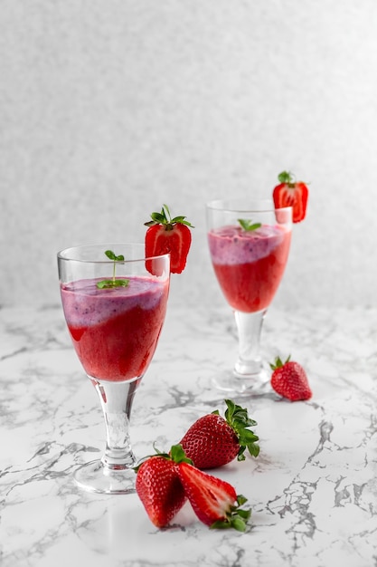 Muesli with yogurt and berries in a glass on a white background