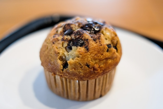 Muffin chocolate lava with chocolate chip and banana smell in paper cup for dessert.