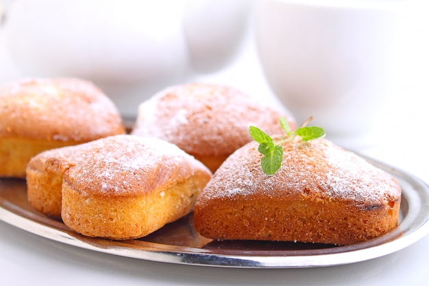 Muffins in the form of heart with powdered sugar