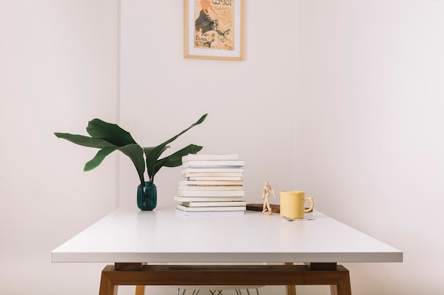 Mug and books on table near decorations