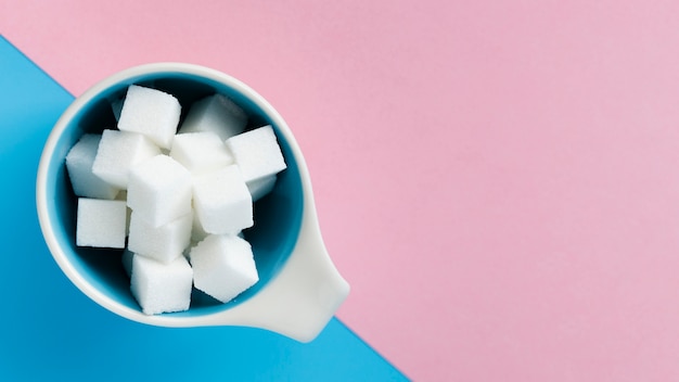 Mug filled with sugar cubes top view