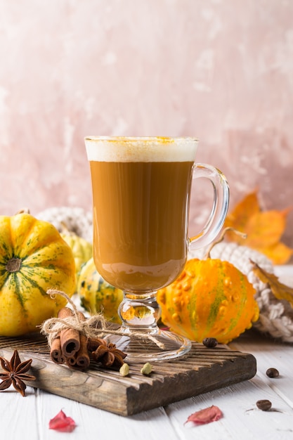 Mug of hot and spicy aromatic pumpkin latte with whipped cream on top