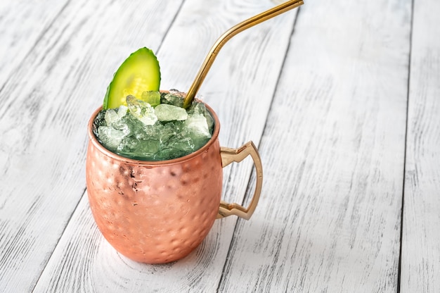 Mug of Sober Mule mocktail garnished with cucumber