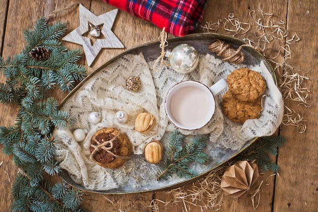 Mug with drink and cookies with Christmas decoration