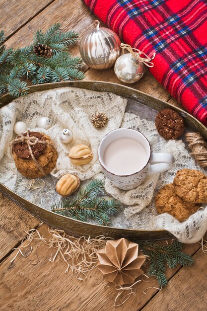 Mug with drink and cookies with Christmas decoration