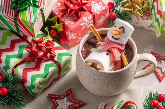 Mug with hot chocolate with melted marshmallow snowman