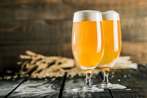 Mugs of cold beer with foam, close-up view