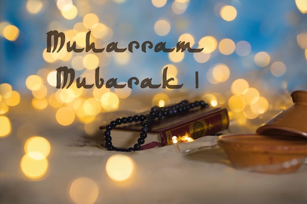 Muharram Mubarak Happy Islamic YearxDHoly book of Quran and praying beads on it