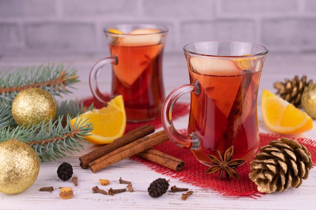 Mulled wine in glass cups and Christmas decorations