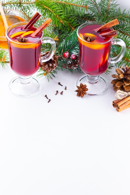 Mulled wine in glass mug with spices Glasses of mulled wine with cinnamon anise and fir tree