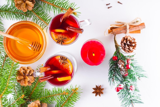 Mulled wine in glass mug with spices Glasses of mulled wine with cinnamon anise and fir tree