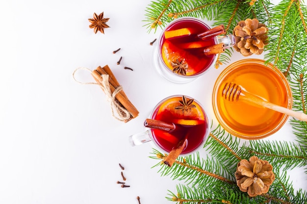 Mulled wine in glass mug with spices Glasses of mulled wine with cinnamon anise and fir tree