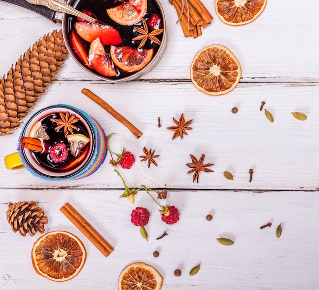 Mulled wine in a mug and ingredients 