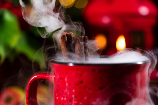 Mulled wine in a red mug on the autumn table