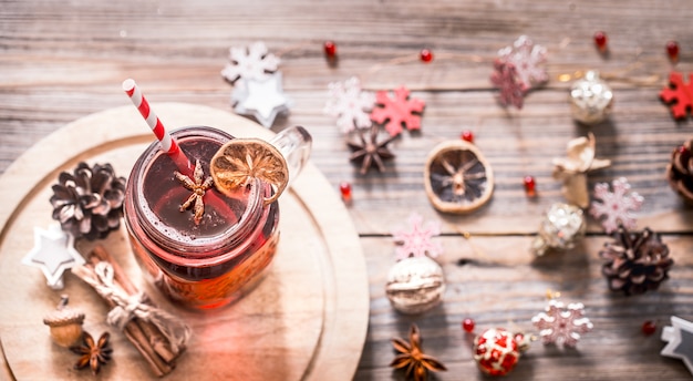 Mulled wine with spices and wooden snowflakes