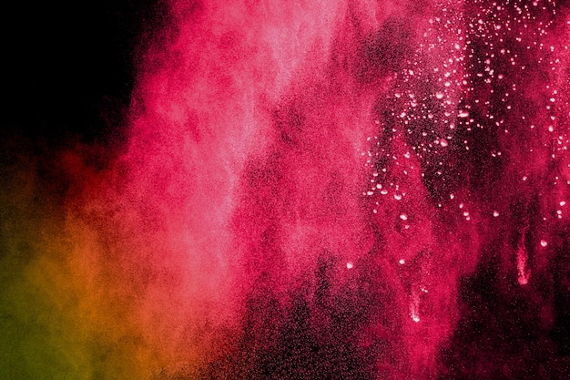 Multi color powder explosion on black background.