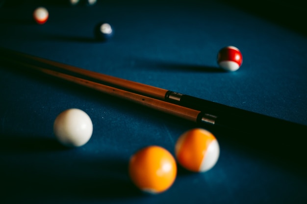 Multi-colored billiard balls on a blue table