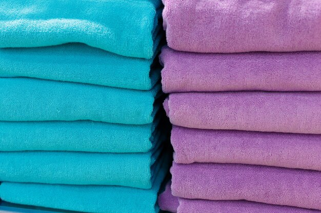 Multi-colored sets of towels on a shelf in a store