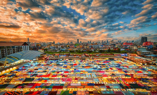 Multi-colored tents in Market train a second-hand market at sunset in Bangkok, Thailand