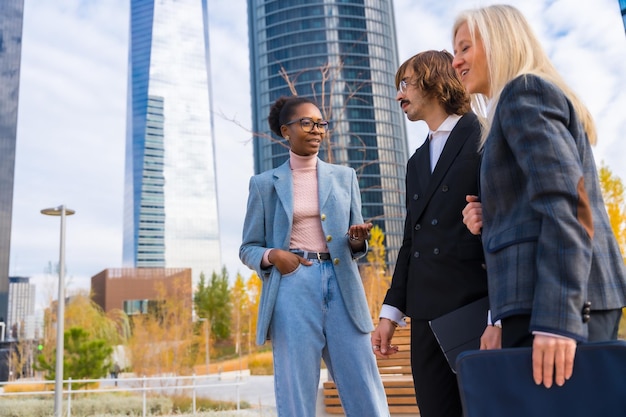 Multi ethnic business colleagues or executives talking to each other in a business park