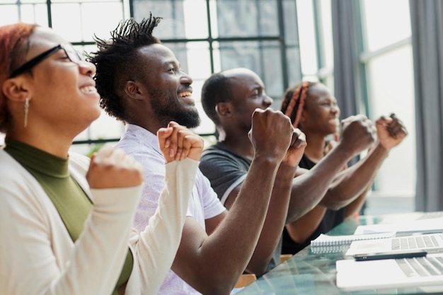 Multi ethnic business group greets somebody with clapping and smiling