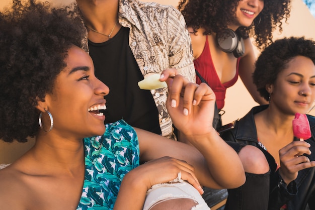 Multi-ethnic group of friends enjoying summertime while eating ice cream