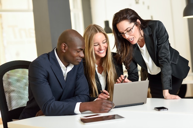 Multi-ethnic group of three businesspeople meeting