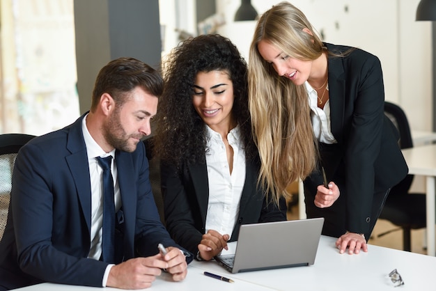 Multi-ethnic group of three businesspeople meeting 