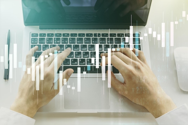 Multi exposure of abstract creative financial chart with hand typing on computer keyboard on background research and analytics concept