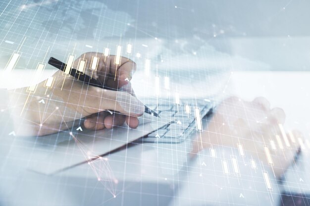 Multi exposure of abstract creative financial chart with world map and with hand writing in notebook on background with laptop research and analytics concept