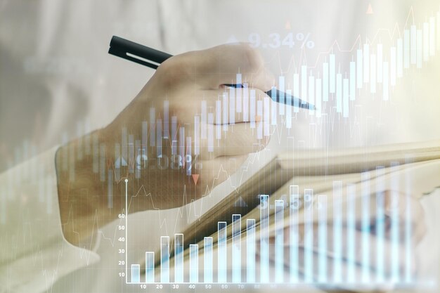 Photo multi exposure of abstract financial diagram with hand writing in notepad on background banking and accounting concept