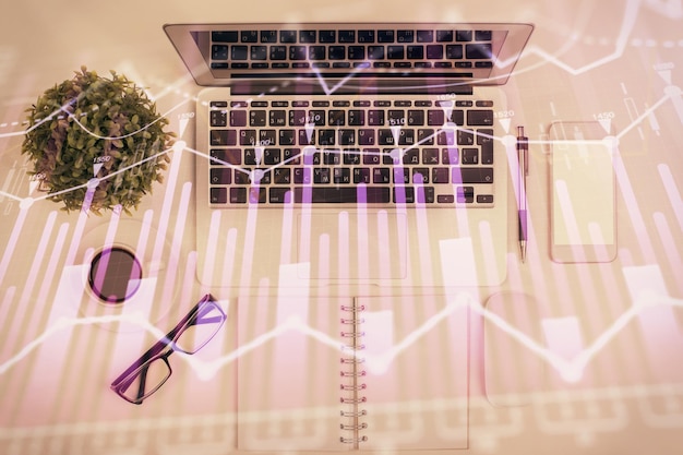 Multi exposure of forex chart drawing over table background with computer Concept of financial research and analysis Top view