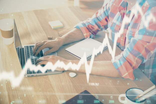 Multi exposure of forex graph with man working on computer on background Concept of market analysis