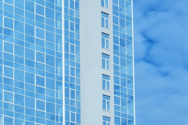 Multi-story glass office building against the sky