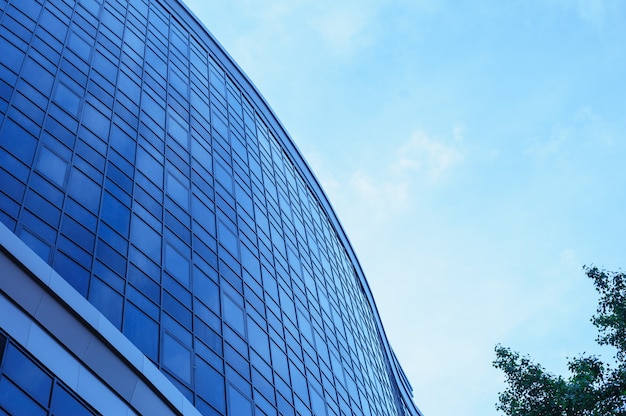 Multi-story glass office building against the sky