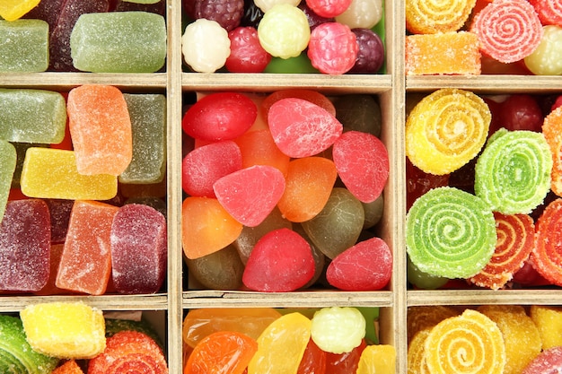 Multicolor candies in wooden box close up