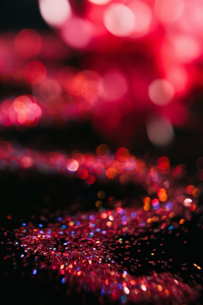 Multicolor glitter on black contrast background Defocused bokeh blur flares concept