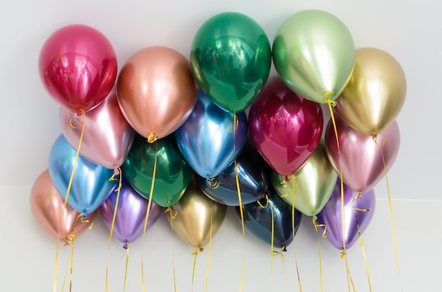 Multicolor helium balloons floating on the ceiling