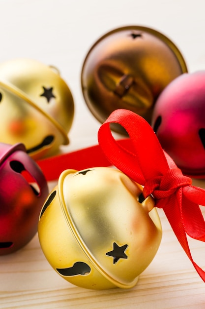 Multicolor jingle bells with red ribbon.