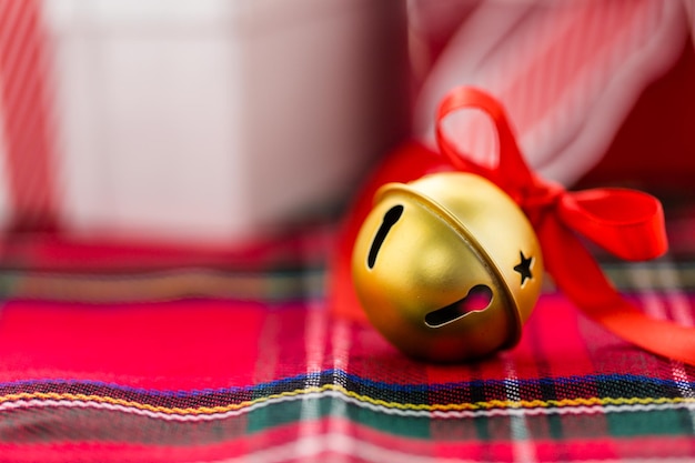 Multicolor jingle bells with red ribbon.