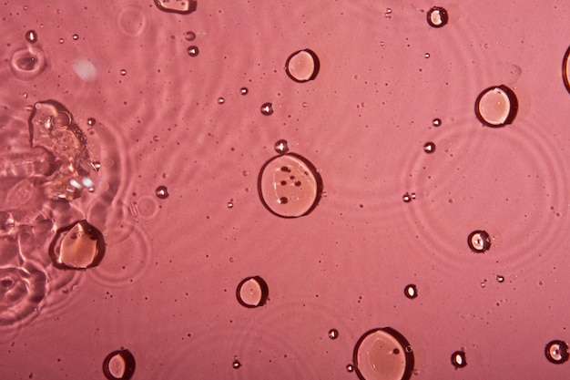 Multicolor water background with bubbles macro olive oil on pink background