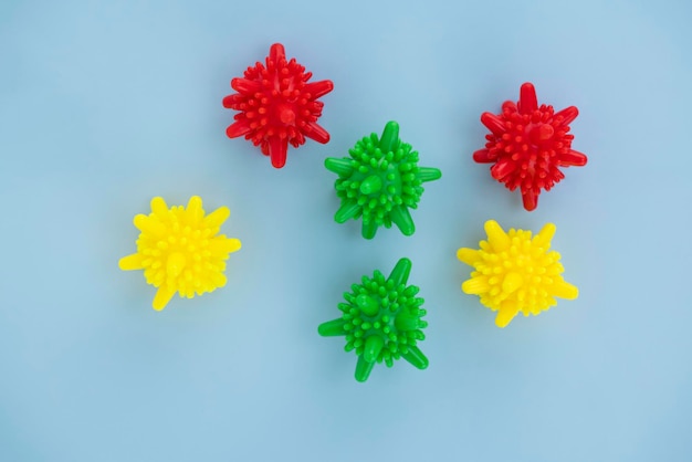 Multicolored balloons coronavirus symbol on blue background with copy space