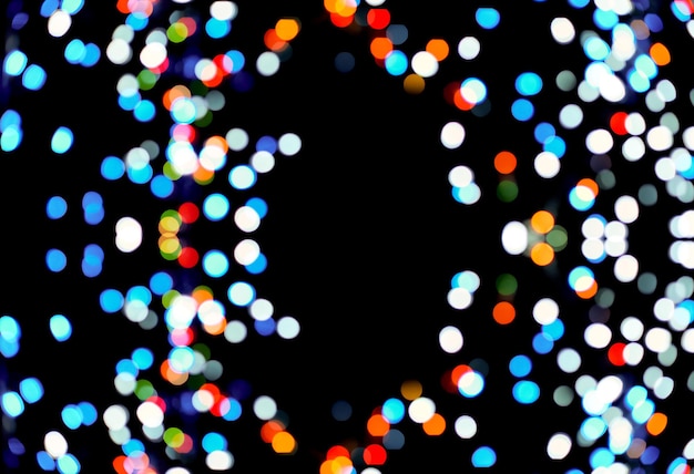 Multicolored bokeh on a black background blurry lights of light bulbs