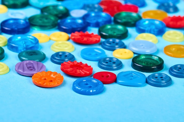 Multicolored buttons for clothess on a blue background