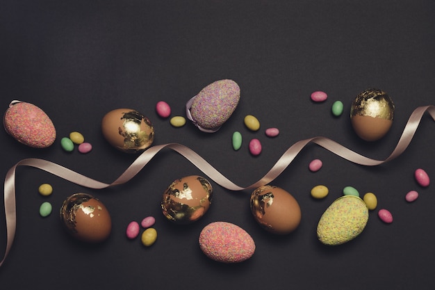 Multicolored candies, eggs and ribbon