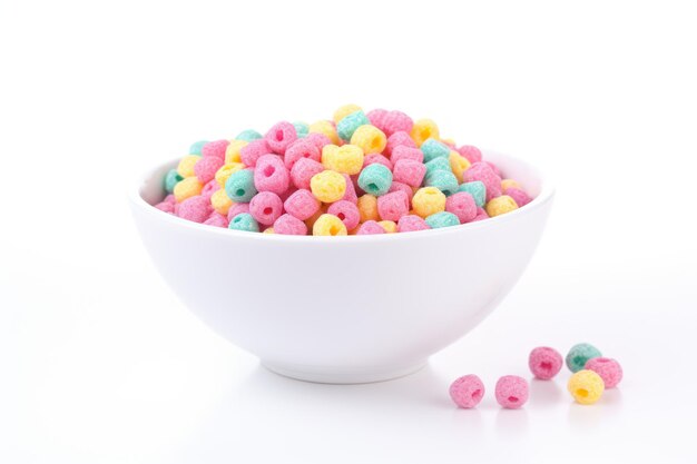 Multicolored cereals in a bowl on white background